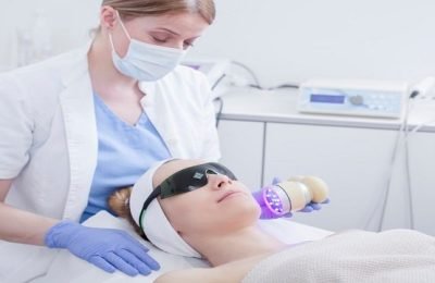 Face skin care. Woman getting facial laser treatment